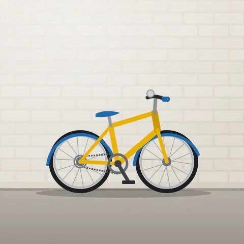 A small yellow kids’ bike with a bell on the handlebars, side on