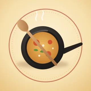 A cast iron pan with a wooden spoon across it, inside a ring