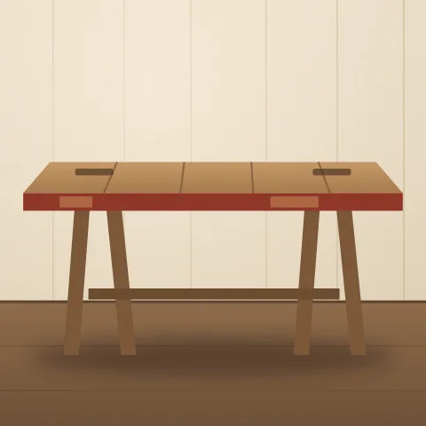 A long table whose top is an old barn door, red paint still on its edge, on two trestle legs