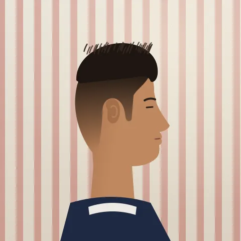 A man’s head side on, with a skin fade blending up into a short textured top