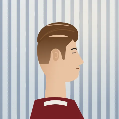 A man’s head side on, with a neat scissor cut and a side part