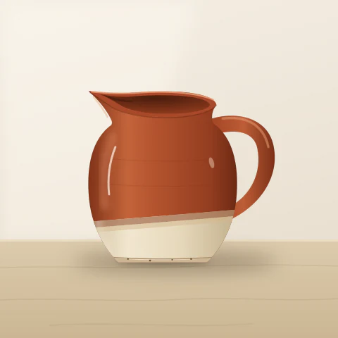 A rust red jug with a handle and a cream dipped base